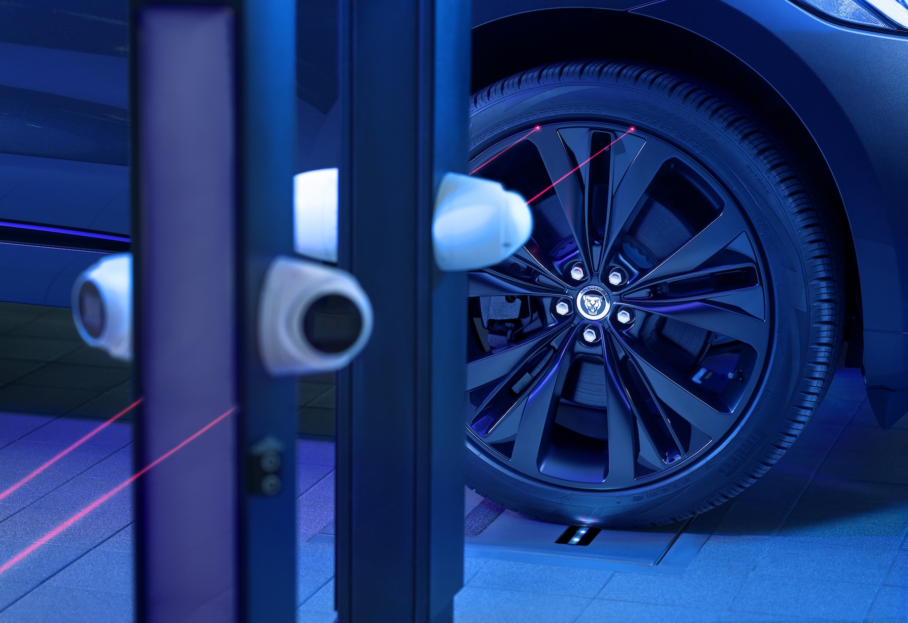 A close-up view of a car wheel, specifically focusing on the brake caliper and part of the rim. The brake caliper is black and has the word 'JAGUAR' written on it in white letters